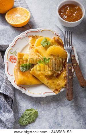 Crepe Suzette. Traditional French Crepe Suzette With Orange Sauce . Top View, Flat Lay