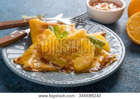 Crepe Suzette. Thin Crepes Suzette With Orange Slices And Marmalade For Breakfast