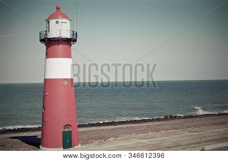Domburg Lighthouse At The Sandy Beach Against Blue Sky With White Clouds At The Coast Of Domburg, Ne