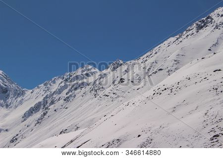Natural Monument El Morado, Central Andes Of Chile. A Snowy Mountain Slopes