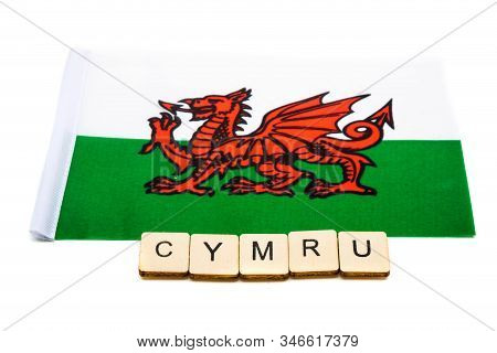 The National Flag Of Wales On A White Background With A Sign Reading Cymru
