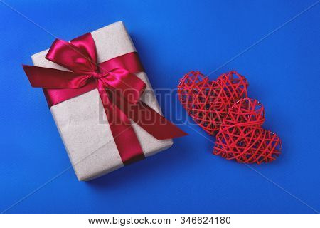 Two Beautiful Red Hearts And A Present On The Cornflowerblue Background. St Valentines Concept With 