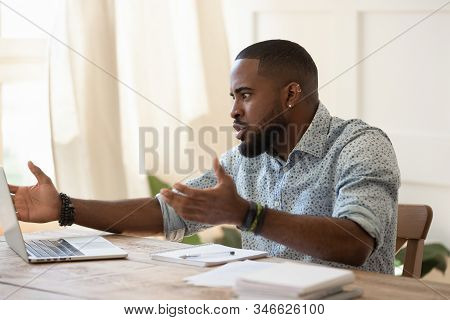 African Guy Looks At Pc Screen Talking Feels Outraged