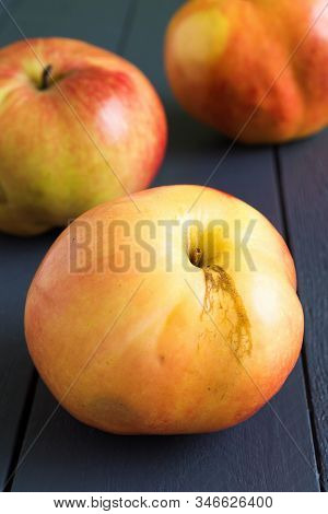 Ugly Apples With Defects On The Skin On The Wooden Gray Background Close Up. Imperfect , Deformed Sh
