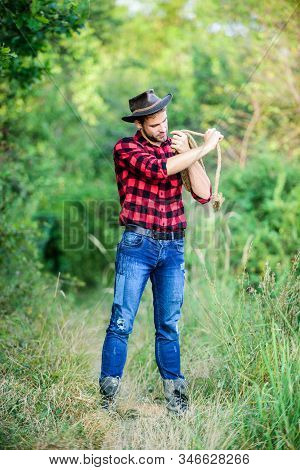 Man Wearing Hat Hold Rope. Ranch Occupations. Lasso Tool. American Cowboy. Lasso Tied Wrapped. Weste