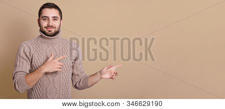 Happy Beautiful Bearded Guy With Good Looking Appearance, Looking At Camera, Smiling And Pointing As