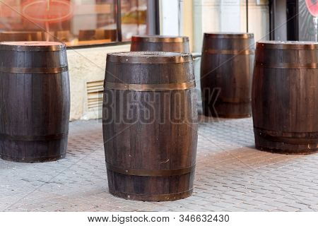 Brown Wooden Wine Barrel On The Street On Stone Paving Slabs, Bar Restaurant Decorations Close Up No
