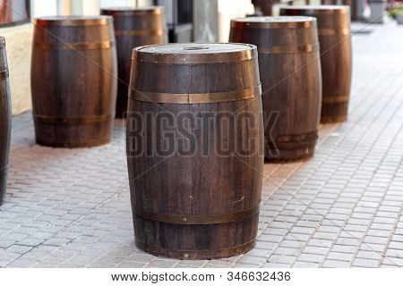 Brown Wooden Barrel On The City Street On Stone Tile, Row Decorations Close Up Nobody.