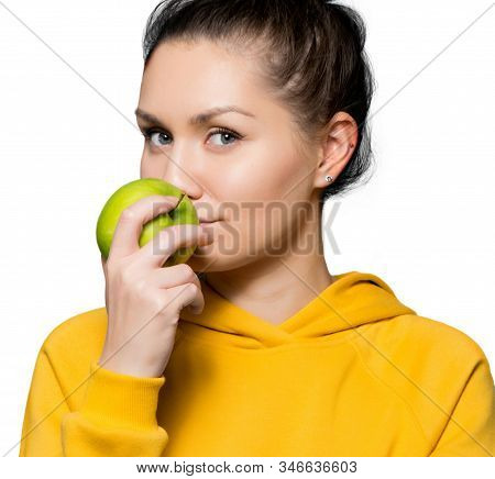 Close Upportrait Of A Girl Who Touches The Lips Of A Green Apple, Isolated