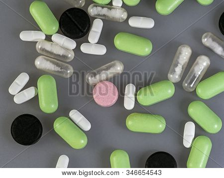 Tablets And Capsules From Various Diseases Are Scattered On The Surface. View From Above. Colored Ba