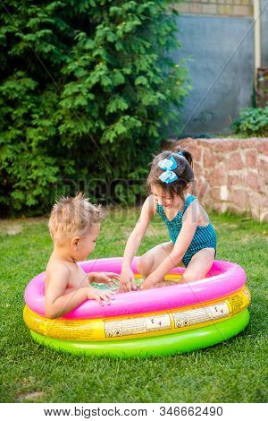 Kids Having Fun Party Swimming In Back Yard Pool. Funny Children Bathing In The Outdoor Pool. Happy 