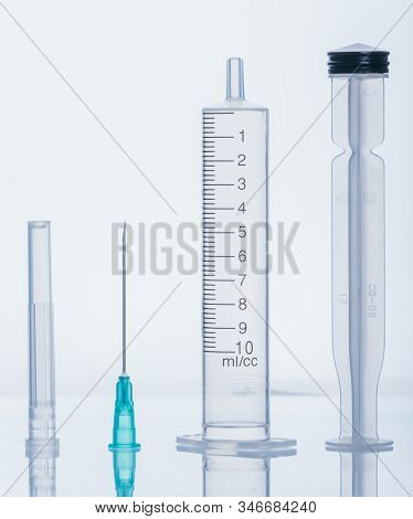 Medical Disassembled Syringe With Needle Isolated On White, Macro Shooting. Syringe Is Disassembled 