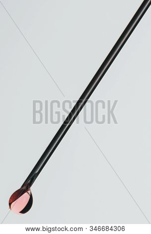 Medical Syringe Needle Isolated On White, Macro Shooting. Isolated Needle Filled With Red Medication