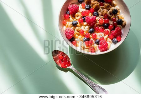Deliscious Healthy Breakfast With Flakes And Fruits Isolated On Green Background.muesli With Yogurt 