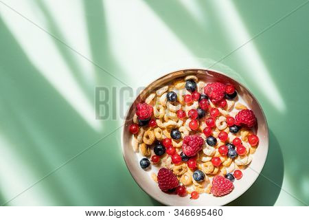 Deliscious Healthy Breakfast With Flakes And Fruits Isolated On Green Background.muesli With Yogurt 