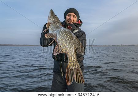 Pike Fishing. Happy Fisherman Holding Big Fish At Boat