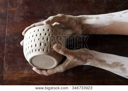 Female Hands Hold A Wet Clay Bowl. Pottery Making