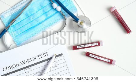 Coronavirus Blood Test Concept. Top View Desk In Hospital With Coronavirus Test Medical Form, Test T