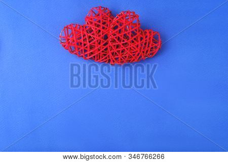 Two Beautiful Red Hearts On Cornflowerblue Background. St Valentines Concept With Copy Space.