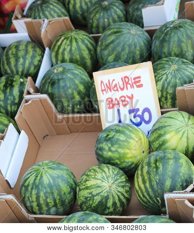 Many Fruits And The Italian Text That Means Baby Watermelons For Sale