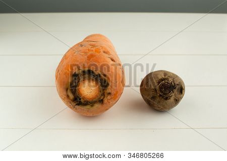 Ugly Vegetables. Carrots And Beets On A White Wooden Background. The Form Does Not Affect The Taste,