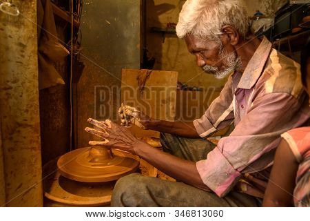 Bangalore, India - March 10, 2019: Indian Potter Making Clay Pots On Pottery Wheel In Pottery Town I