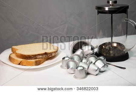 Coffee Capsules In Falling Cup, Plate Of Bread And French Press Coffee Maker, Breakfast Concept