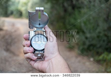 Compass In Hand By A Country Road