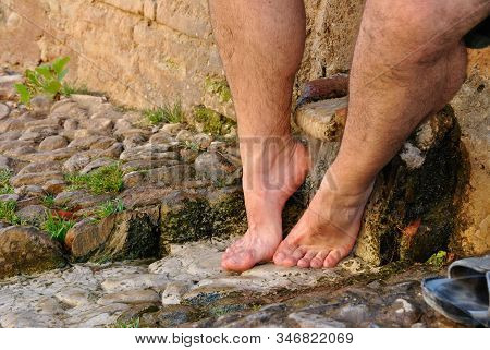 Feet Of Man Getting Wet In The Creek