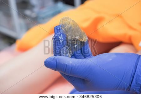 Woman Making Sugaring Hair Removal Procedure At Beauty Salon. Cosmetologist Make Epilation With Liqu