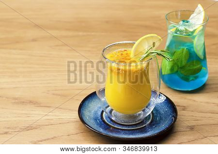 Hot Winter Sea-buckthorn Tea With Citrus Fruits And Rosemary In A Double-walled Glass. Cold Summer M