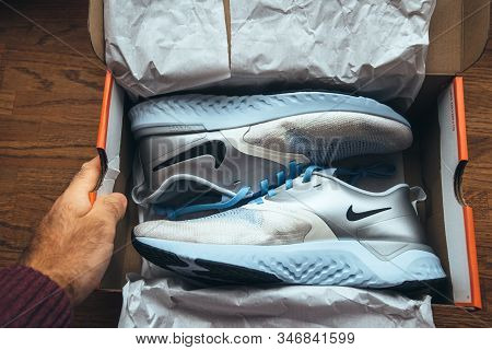 Paris, France - Sep 23, 2019: Personal Perspective Unboxing Unpacking On Wooden Table Pair Of New Ni