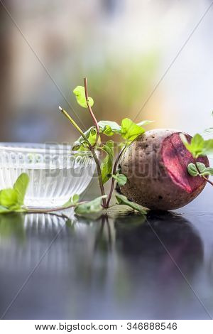 Home Remedy For Dandruff On Wooden Surface I.e., Beetroot Stock Well Mixed With Water In A Glass Bow