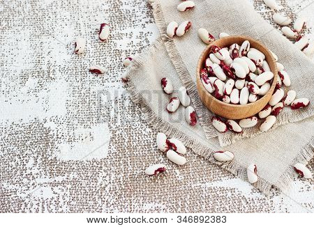 White-pink Beans In A Wooden Cup On A Light Background