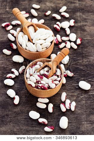 Colored Beans In Wooden Cups On A Dark Wooden Background