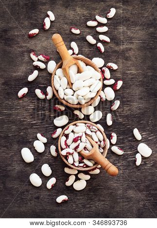 Colored Beans In Wooden Cups On A Dark Wooden Background