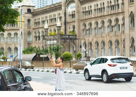 The Kuala Lumpur Railway Station. Malayan Railways Hub. Young Woman Tourist Walk Around Building. Ku