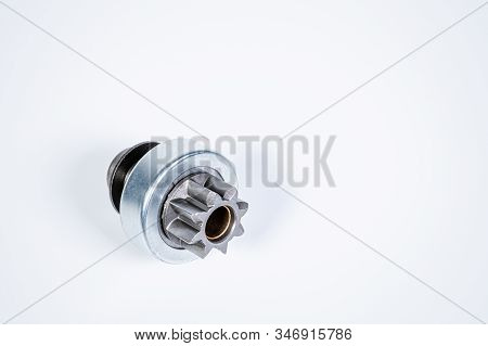 New Spare Parts - Starter Gear Drive For Motor Starter On A Gray Background. Classic Gear Transmissi