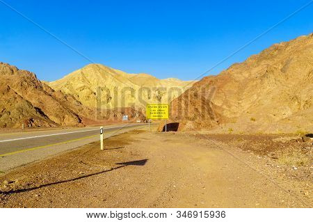 View Of Desert Road 12, With A Trilingual Warning Sign (dangerous Curves) And Landscape. Eilat Mount