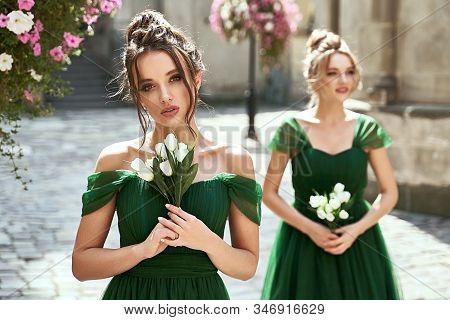 Two Beautiful Bridesmaids Girls Blonde And Brunette Ladies Wearing Elegant Full Length Off-the-shoul