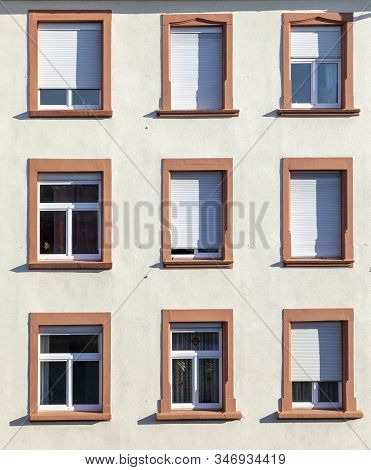 Facade Of Old Urban Houses With Windows And Shutterblinds