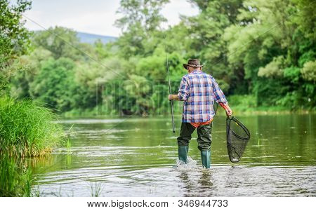 Calling Fly-fishing A Hobby. Fisherman With Fishing Rod. Retired Bearded Fisher. Trout Bait. Hobby A