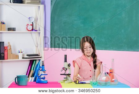 Biology Education. Science Lesson. School Laboratory. Small Girl With Microscope. Girl Biology Class