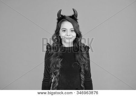 Little Devil. Little Girl Red Horns Celebrate Halloween. Carnival Concept. Small Child With Imp Styl