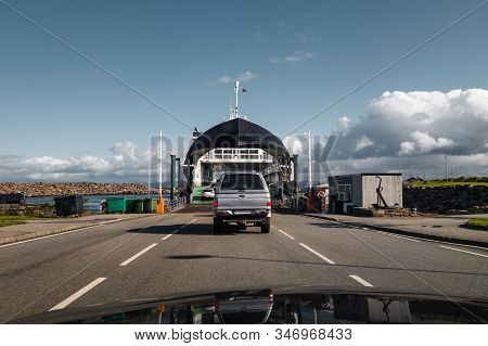 Cars Driving On The Ferry At Mortavika That Is Transporting Them To Arsvågen On A Bright Day, Norway