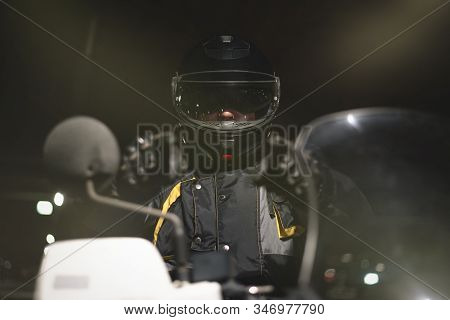 Biker In Helmet Is Showing Ahead By His Index Finger.