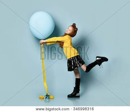 Ginger Teenage Kid With Fancy Hairstyle In Yellow Sweatshirt, Black Skirt, Knee-highs, Boots. Smilin