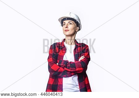 Young Woman In Construction Clothes With Folded Hands On A Light Background
