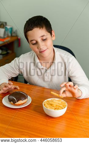 Diet Or Healthy Lifestyle Concept. Happy Boy Eating A French Fries. Painful Preteen Boy Having Abdom