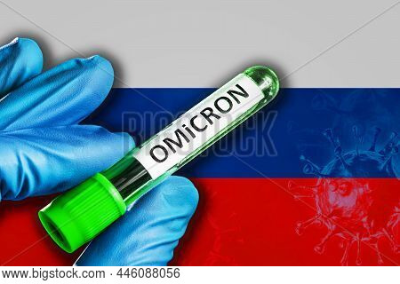 Russia Outbreak Of Omicron Variant. A Hand In A Blue Rubber Glove Holds A Test Tube With Covid-19 Vi